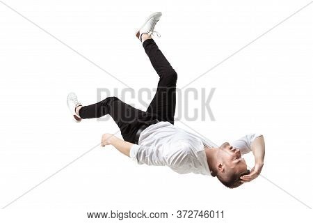 Mid-air Beauty Cought In Moment. Full Length Shot Of Young Man Hovering In Air And Keeping Eyes Clos