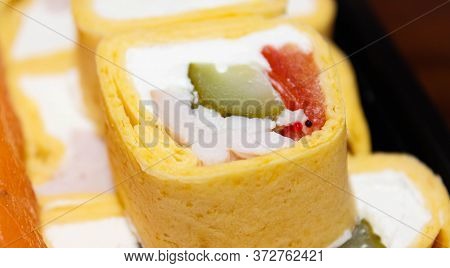 Sushi Rolls Wrapped In Omelet Close-up On A Plate For Dinner. Delicious And Delicious Food. Selectiv