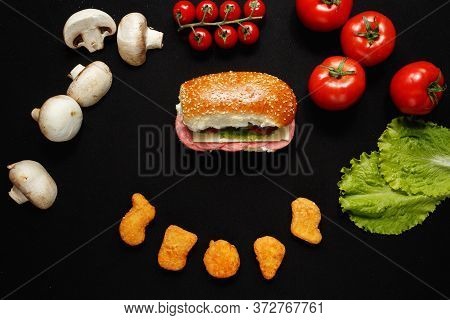 Ingredients For Pizza, Burger Or Sandwich. Chicken Naggets. Vegetables On A Dark Background