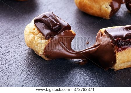 Traditional French Dessert. Eclair With Chocolate Icing. Pastery Dessert Concept