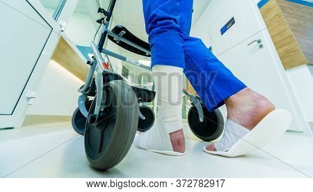 Patient On Rollator With Hand Brakes Moving In Hospital