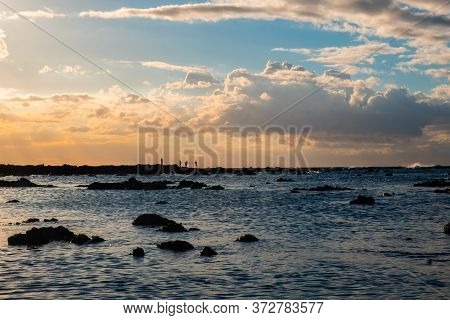 People Are Fishing At Sunset. Beautiful Sky On The Background.