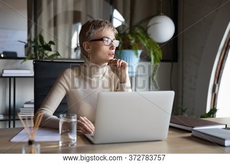 Businesswoman Planning New Creative Ideas Sitting At Desk In Office
