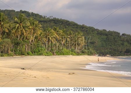 One Person Alone On Empty Beach At Pantai Setagi, Near Senggigi, Lombok, Indonesia. Exotic Tropical 