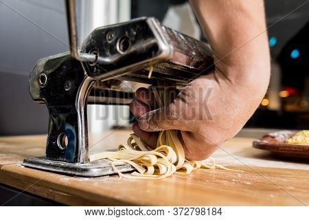 Chef Rolling Dough With A Pasta Machine. Pasta Maker Machine.