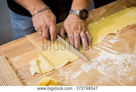 Chef Rolling Dough With A Pasta Machine. Pasta Maker Machine.