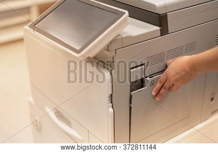 Female Hand Pressing The Touchscreen Monitor Of The Copy Machine For Copy A Paper Document, Scanner 