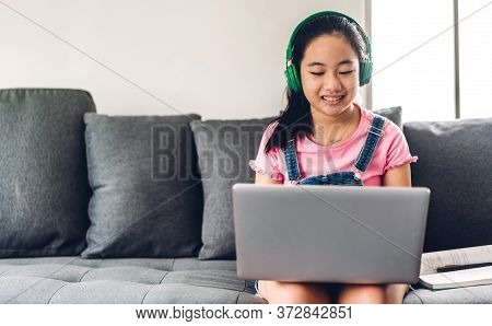 School Kid Little Girl Learning And Looking At Laptop Computer Making Homework Studying Knowledge Wi
