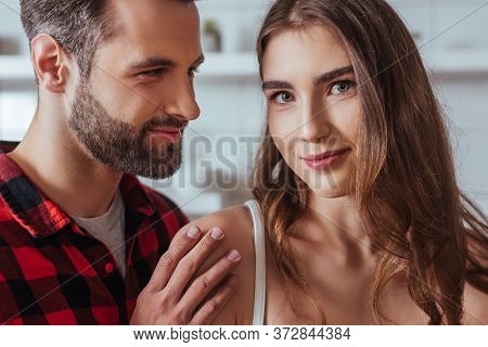 , Beautiful Girl Looking At Camera While Handsome Boyfriend Touching Her Shoulder
