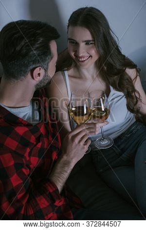 High Angle View Of Cheerful Girl Clinking Glasses Of White Wine With