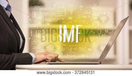 hand working on new modern computer with IMF abbreviation, modern technology concept