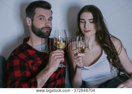 Man And Attractive Girl Holding Glasses Of White Wine