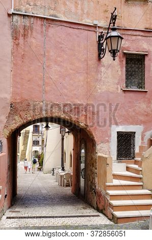 Mother And Father With Their Son Walking Together In Italian Picturesque Village. San Felice Circeo,