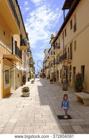 A Little Girl Standing In The Picturesque Italian Village. San Felice Circeo, Lazio, Italy