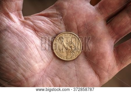 American Us Coin 1 Dollar Buck Lie On A Dirty Palm Close Up. An Impressive, Dramatic Shot With An Ag
