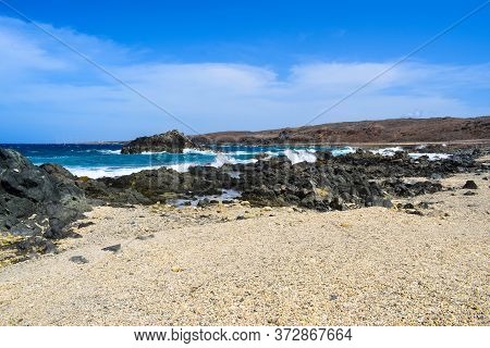 Arikok Natural Park On The Island Of Aruba In The Caribbean Sea With Deserts And Ocean Waves On The