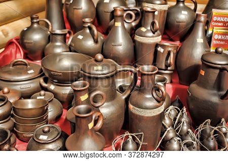 Traditional Ceramic Jugs On Decorative Towel. Showcase Of Handmade Ceramic Pottery In A Roadside Mar