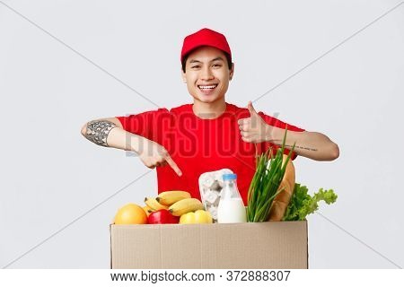 Online Shopping, Food Delivery And Internet Stores Concept. Smiling Friendly Courier In Red T-shirt 
