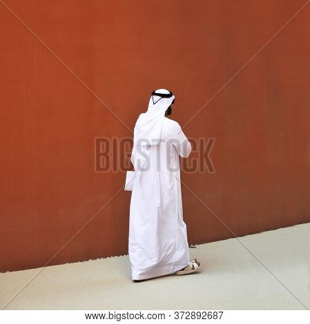 An Elegant Man Of Arab Ethnicity With Sunglasses Walks The Streets Of His Country