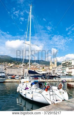 BASTIA, FRANCE - SEPTEMBER 16, 2018: A view of the Vieux Port, the Old Port of Bastia, in Corsica, France, highlighting the Saint-Jean-Baptiste Church in the background