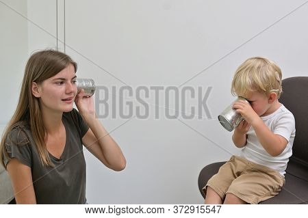 A Boy With Cochlear Implants Playing Tin Can Phone