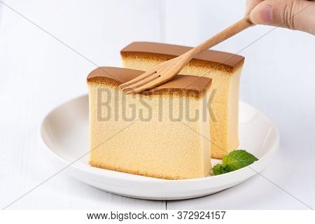 Castella (kasutera) - Beautiful Delicious Japanese Sliced Sponge Cake Food On White Plate Over Rusti