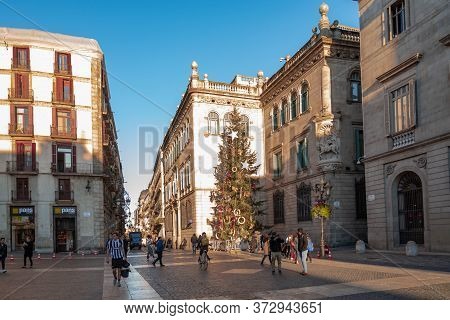 Barcelona, Spain - December 19, 2018: People Walk In Front Of The Generalitat Palace Of Catalonia In