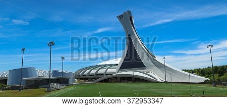 MONTREAL, CANADA- AOUT 10, 2018:  Olympic Stadium for 1976 Games and Biodome, one of four facilities that make part of the largest natural science museum complex  in Montreal, Canada.