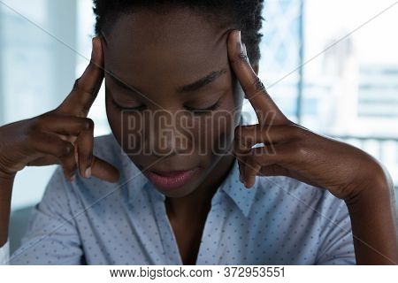 Depressed female executive sitting in futuristic office