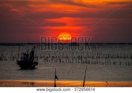 Beautiful Landscape View Of Sunset Time Going Down To In The Sea With Foreground Of Beach In Tropica