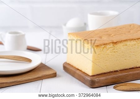 Plain Classic Taiwanese Traditional Sponge Cake (taiwanese Castella Kasutera) On A Wooden Tray Backg