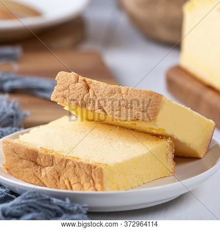 Plain Classic Taiwanese Traditional Sponge Cake (taiwanese Castella Kasutera) On A Wooden Tray Backg