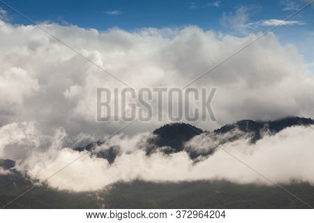 A Nature Of Landscape View Of Mountain With Clear Blue Sky And Foggy Environment Located At Tropican