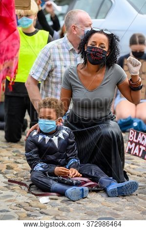 Richmond, North Yorkshire, Uk - June 14, 2020: A Powerful Bame Woman Wears A Black Lives Matter Ppe 