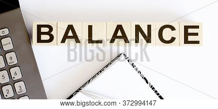 Business Concept Text On Wood Block Balance With Notebook And Laptor