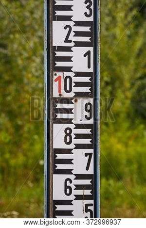 Stream gauge rod in a river