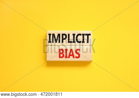 Implicit Bias Symbol. Concept Words Implicit Bias On Wooden Block. Beautiful Yellow Table Yellow Bac
