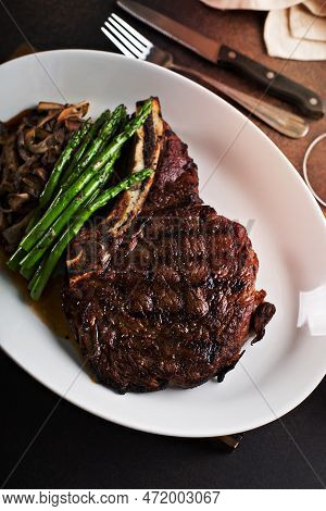 Bone-in Ribeye Beef Steak Sliced With Mushrooms And Asparagus