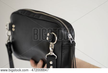 Details Of Leather Black Handmade Bag Over His Shoulder. Dark Designer Banana Bagon A White Backgrou
