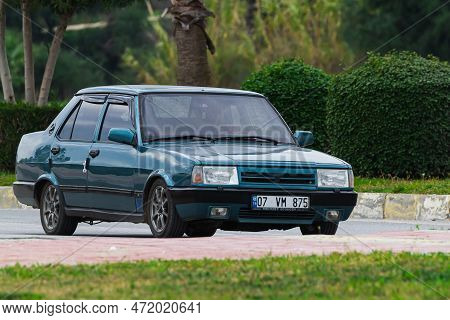 Side, Turkey -january 27, 2023:     White Tofas Dogan  Driving  On The Street On A Warm Summer Day