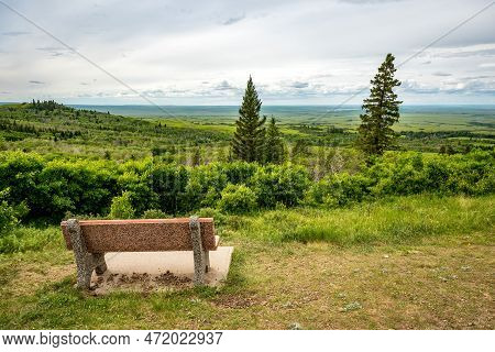 A Bench Overlooking Lookout Point In Cypress Hills Interprovincial Park, Saskatchewan