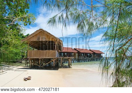 Typical Wooden Water Bungalows On The Beach - Waigeo Island, Raja Ampat, West Papua, Indonesia