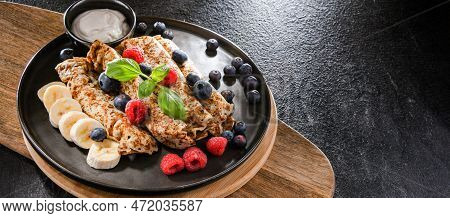 A Plate Of Pancakes With Cheese And Fruits