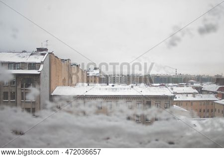 View From A Snow-covered Window On The Roofs Of St. Petersburg