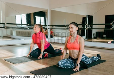 Fitness Trainer And Mentee Over Gym Room Background. Sport And Healthy Active Lifestyle Concept. Ind