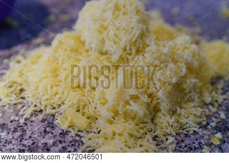 A Pile Of Grated Potatoes On A Marble Countertop