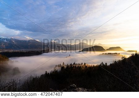 2022 12 30, Bled, Slovenia: Lake Bled Covered In Fog With Island Bled Peaking Through And Castle Ble