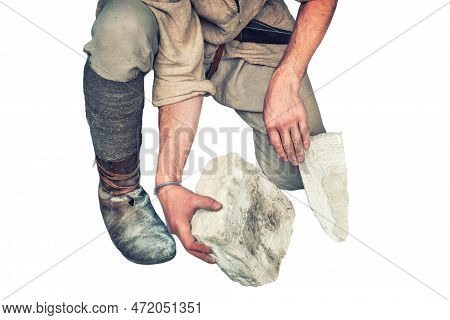 Working In A Quarry Holding Stones, Isolated On A White Background. The Mason Chooses A White Limest