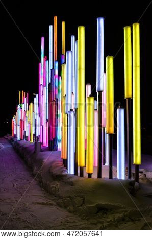 Abstract Light Poles Standing In The Snow.