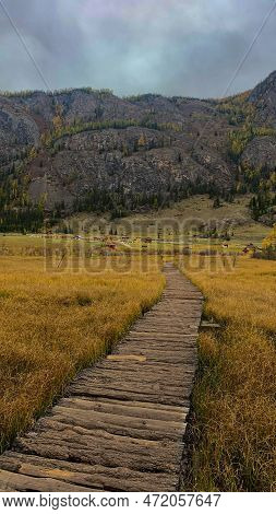 A Wooden Path Going Straight To The Foot Of The Mountain.